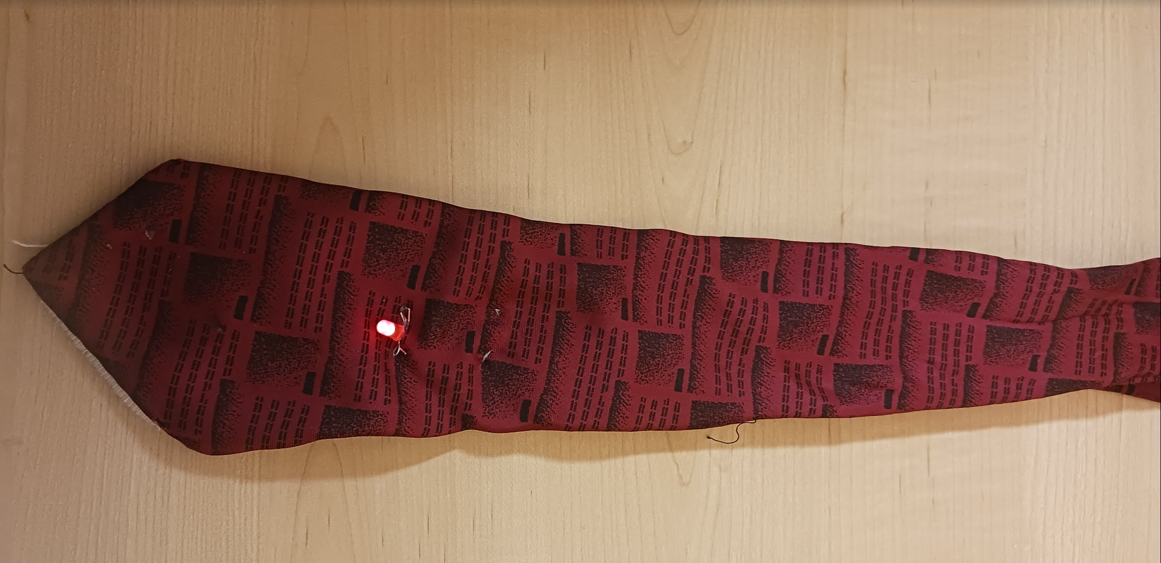 A tie with an LED that light up when the two clasps on it are connected